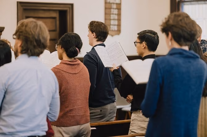 Congregation standing and singing psalms from psalters