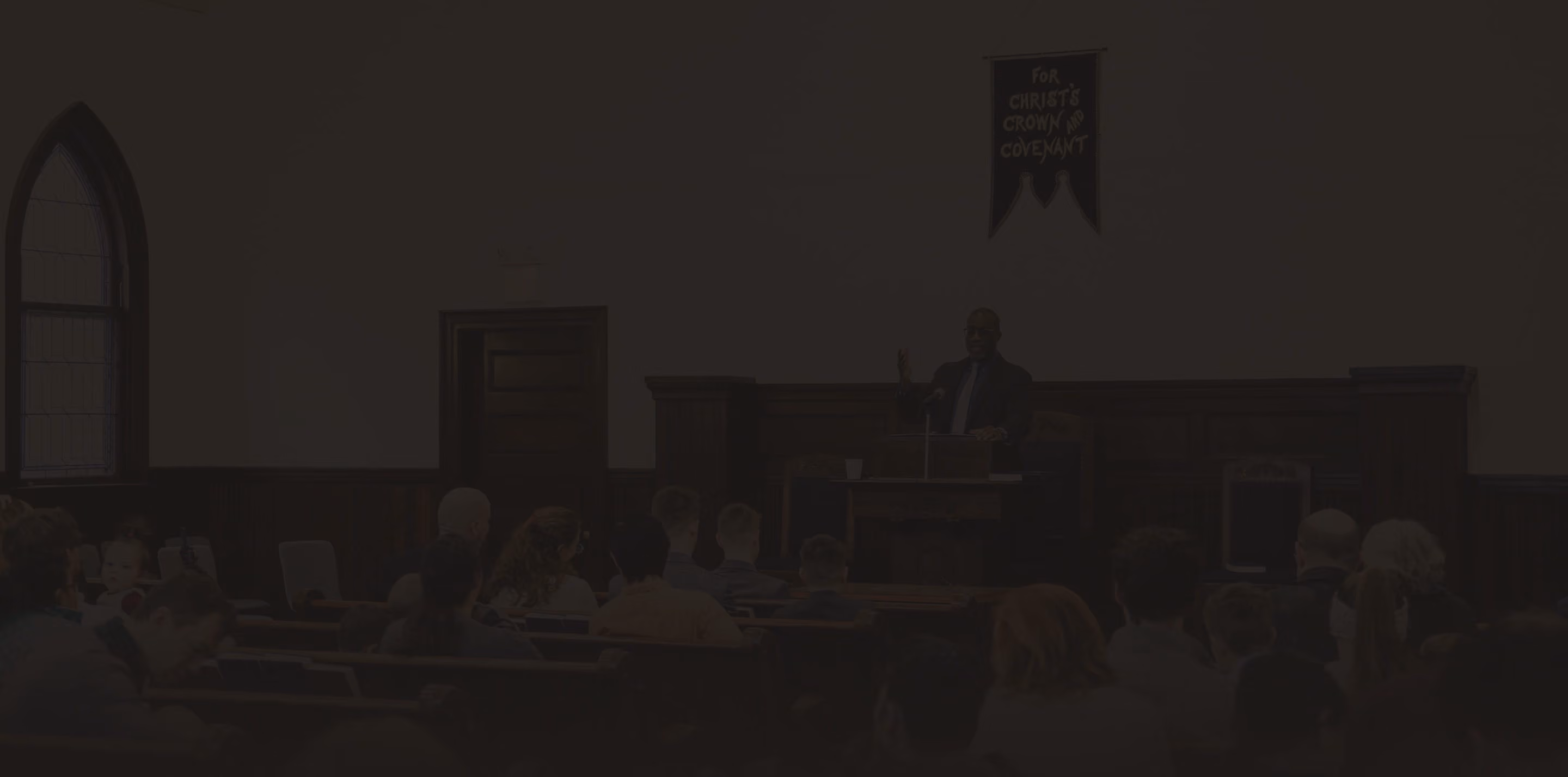Dimly lit view of the sanctuary during a worship service